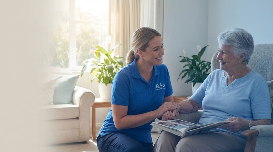 Professional carer providing patient, compassionate support to elderly person with dementia in calm home environment